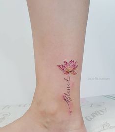 a lotus flower with the word love written in cursive writing on the ankle