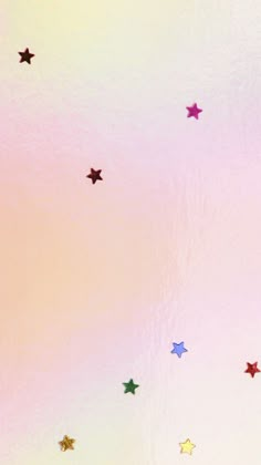 colorful stars are flying in the sky on a pink and yellow background