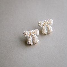 what we love about these earrings: •cutest chunky bow shape •gold filled base and posts •white pearls all over Bow Earrings, Gold Plated Silver, Earring Necklace, Our Love, Pearl White, Bag Sale, Ear Cuff, Gold Filled, Polymer Clay