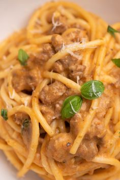 pasta with meat and cheese in a white bowl