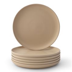 a stack of beige plates sitting on top of each other