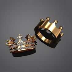 two gold rings with diamond crowns on them