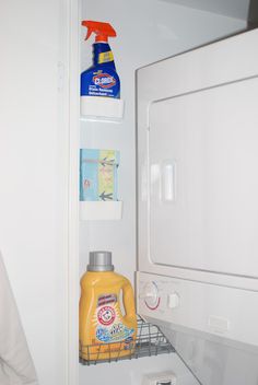 an open refrigerator door with cleaning products on the shelf