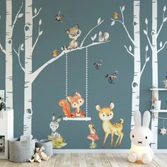 a child's room with woodland animals on the tree wall decals and a swing