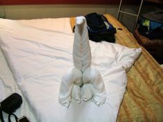 a towel animal sitting on top of a bed