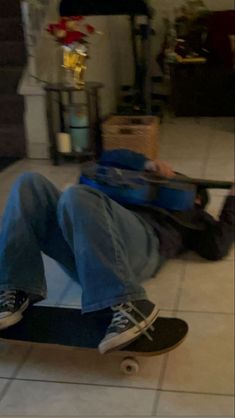 a man laying on the floor with his skateboard