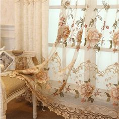 the curtains in this room are decorated with flowers and lace trimmings on them