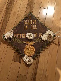 a graduation cap with flowers on it that says i believe in the future of ag