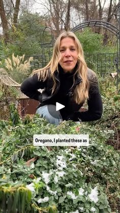 a woman sitting in the middle of a garden