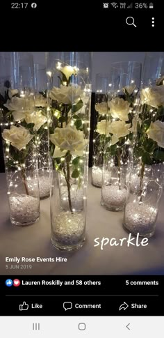 there are many vases with flowers in them and lights on the top one is white