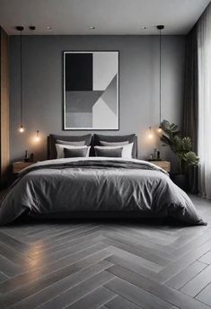 a bedroom with grey walls and wood flooring is pictured in this image, there are candles on either side of the bed