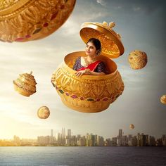 a woman is sitting in a gold pot floating above the water and surrounded by other objects