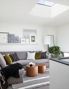 a living room filled with furniture and pictures on the wall above it's coffee table