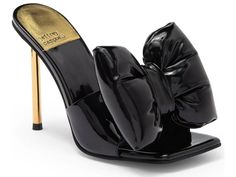 Bow-Down Heel in Black Patent Gold By: Jeffrey Campbell Pin-heel sandal with an exaggerated bow. Fits true to size Measurements taken from a size 7 4.5" heel Synthetic Upper, Leather Lining, Synthetic Sole