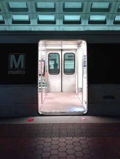 an open train door at night with the light on