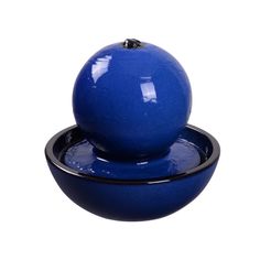 a blue bowl with a black base and an apple on top that is sitting in front of a white background