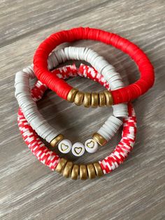 Red and white Vinyl Heishi beads (8mm) paired with wooden gold rondelle beads on elastic cord. The bracelet measures 7 inches around. This listing is for the red and white and gold bead bracelet only but you can find the other bracelets in our shop at https://www.etsy.com/shop/Immeasurablymore2 Follow Immeasurably More on Instagram immeasurablymore_) for special announcements, coupon codes, and giveaways. Flat Bead Bracelet Ideas, Valentine Bracelets, Bracelets Preppy, Heishi Bead Bracelet, Bracelet Valentines, Heishi Bracelet, Preppy Bracelets, Valentines Bracelets, Red Beaded Bracelet