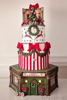 a three tiered cake decorated with christmas decorations