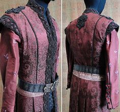 the back and side views of a medieval costume, which is worn in red with black trim