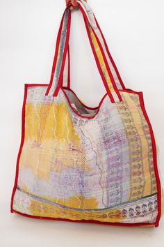 This bag is made from a vintage hand-stitched Kantha quilt. We make only 1-2 bags from each quilt and every one of them is one of a kind! Details: Shell fabric- Vintage Quilted Cotton Kantha 1. width (cm) - 40 2. height (cm)- 45 3. depth (cm) - 45 4. weight (g)- 0.400 kg 5. length of the shoulder (cm) -40 cm Care instructions: Dry clean or Hand-wash in warm water. Drip dry. How it's made: Kantha quilts are made using numerous layers of recycled silk or cotton saris which are hand-stitched in the Yellow Bohemian Rectangular Bag, Yellow Rectangular Bohemian Bag, Bohemian Yellow Square Bag, Yellow Square Bohemian Bag, Yellow Artisan Bag For Everyday Use, Bohemian Multicolor Reversible Bag, Multicolor Reversible Bag With Double Handle, Artisan Yellow Bag For Everyday Use, Red Patchwork Tote Bag