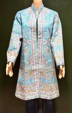 An elegant and stylish woven wool Kani Jamawar Coat in an intricate Paisley Floral pattern on the  front and the back of the jacket.  Soft and lightweight Trench coat perfect for Spring and cool summer days. Crafted from the same famous Kashmiri Kani shawl, expertly woven in Kashmir, using traditional techniques to create a beautiful, timeless piece. The Same Kani Shawl fabric is tailored into a coat.  The coat is lined with soft silky color coordinated fabric and has side pockets on each side.  The coat also has a hook enclosure which is concealed on the front.  A combination of vibrant shades with a beautiful play of colors. Grace any occasion with this casual and traditional jacket and step out of the crowd, Wear it with a pair of jeans, or a complimenting outfit. The perfect accessory, Traditional Open Front Outerwear For Spring, Spring Traditional Open Front Outerwear, Traditional Open Front Spring Outerwear, Bohemian Blue Open Front Outerwear, Blue Silk Outerwear For Fall, Fitted Bohemian Outerwear With Open Front, Fitted Silk Bohemian Outerwear, Fitted Long Bohemian Outerwear, Silk Long Coat For Winter