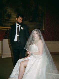 a man in a tuxedo standing next to a woman in a wedding dress