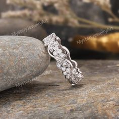 a diamond ring sitting on top of a rock