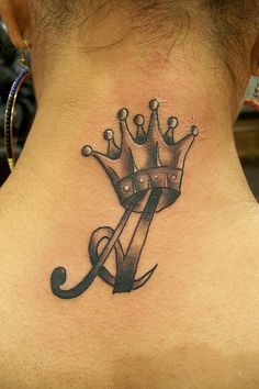 a woman with a crown tattoo on her neck