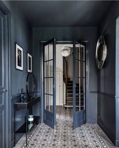 an entry way with blue walls and tile flooring