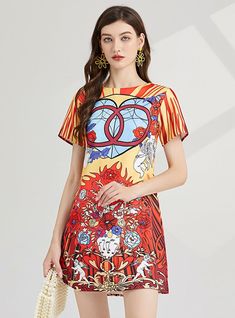 Carnival of Hue: This vibrant, stained glass-inspired dress is a wearable piece of art, flaunting a bold palette of red, yellow, and blue, intermingled with striking patterns that catch the eye. The short-sleeve design, coupled with the A-line silhouette, offers a casual yet flattering fit that moves with grace and ease. It's a piece that celebrates color and creativity, making it a perfect choice for those who love to stand out in a crowd. The kaleidoscopic patterns are not just visually compel Multicolor Graphic Print Summer Dress, Colorful Floral Print Short Sleeve Dress, Summer Multicolor Graphic Print Dress, Red Graphic Print Dress For Spring, Colorful Pattern Short Sleeve Summer Dresses, Yellow Dress With Graphic Print And Short Sleeves, Yellow Short Sleeve Dress With Graphic Print, Yellow Short Sleeve Dresses With Graphic Print, Bold Multicolor Summer Dresses