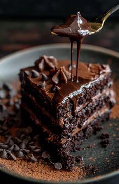 a piece of chocolate cake is being drizzled with chocolate