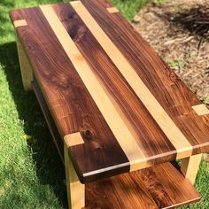 a wooden bench sitting in the grass