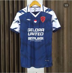 a soccer jersey hanging on a wall with the name gelora united written on it