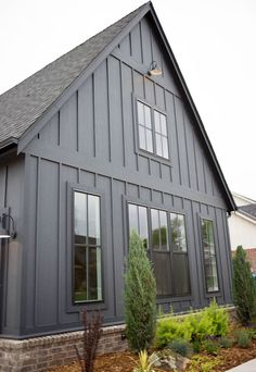 a large gray house with lots of windows