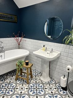 a bathroom with blue walls and white tiles on the floor is pictured in this image