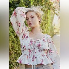 So Femme And Floral, This Timeless Blouse Is Featured In A Romantic Silhouette With Exaggerated Sleeves And Front Tie Feature For Added Dimension. Ruffled Bottom Hem Elastic Waistline Hand Wash Cold Or Dry Clean Measurements For Size M Runs Big Will Fit A L/Xl Sleeve Length: 25” Bust: 42” Waist:31” Relaxed Length: 21” Contents 100% Cotton Feminine Cotton Peasant Top For Spring, Feminine Red Cotton Blouse, Feminine Red Cotton Tops, Red Cotton Feminine Tops, Feminine Summer Peasant Top With Floral Print, Feminine Floral Print Peasant Top For Summer, Feminine Fitted Cotton Peasant Top, Feminine Floral Peasant Top For Summer, Fitted Feminine Cotton Peasant Top