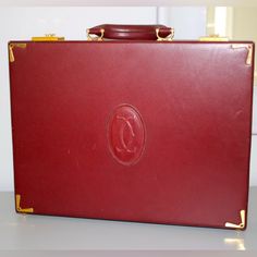 100% Authentic Measurements 16.50" X 13.00" X 3.50" Made In Paris. The Briefcase Is From The "Les Must" De Cartier Collection In Their Iconic Shade Of Burgundy Leather. The Document Holder Has Gold Plated Metal Accents And Is Decorated With The Cartier Monogram. It Has A Metal Plaque That Has Been Stamped "Les Must De Cartier Paris" Logo. The Bag Is In Excellent Condition, Very Clean, And Shows Very Minor Signs Of Wear From Normal Use. Red Rectangular Briefcase For Formal Use, Classic Red Briefcase For Formal Occasions, Luxury Red Briefcase For Formal Occasions, Elegant Red Formal Briefcase, Elegant Red Travel Briefcase, Elegant Red Briefcase For Travel, Vintage Formal Briefcase With Gold-tone Hardware, Cartier Collection, Paris Logo