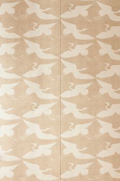 a beige and white wallpaper with birds in flight on the back side of it