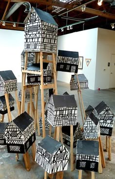 a group of black and white boxes stacked on top of each other in an empty room