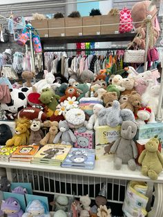 a bunch of stuffed animals are on display in a toy store with other stuff animals