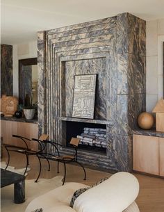 a living room filled with furniture and a fire place in the middle of a room