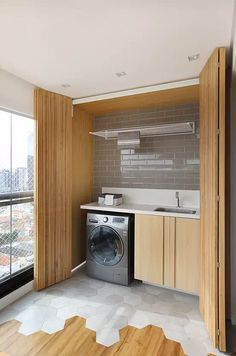 a washer and dryer are in the middle of a room with wood paneling