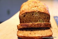 a loaf of bread sitting on top of a wooden cutting board