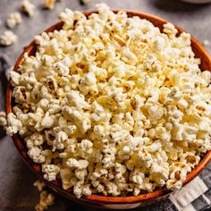 a bowl filled with popcorn sitting on top of a table