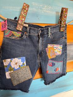 the jeans are decorated with colorful patchwork and flowers on them, along with other patches