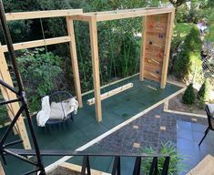 an outdoor play area with swings, climbing bars and other things to do in the back yard