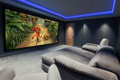 a home theater with two recliners and a large painting on the wall