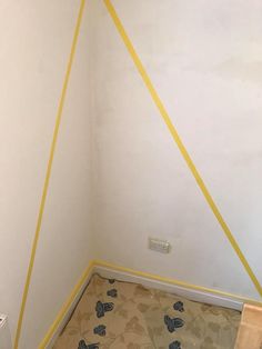 the corner of a room with yellow tape on it