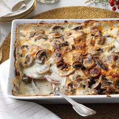 a casserole dish with mushrooms and cheese on it, ready to be eaten