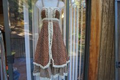 "Brown floral size  5 (fits more like 3) prairie dress. NOT A GUNNE, made by homespun - very rare dress. Condition - has some light fading in color- see last two photos. Measurements taken across front laid flat  16\" across front armpit to armpit 12.5\" across front of waist  45\" length" Prairie Dress With Ruffles For Daywear, Daywear Prairie Dress With Ruffles, Ruffled Prairie Dress For Daywear, Pastoral Prairie Dress With Ruffles For Garden Party, Pastoral Prairie Dress For Garden Party, Peasant Prairie Dress With Ruffles For Gatherings, Cottagecore Prairie Dress With Ruffles And Square Neck, Cottagecore Vintage Dress With Ruffles And Square Neck, Cotton Prairie Dress With Ruffles For Garden Party